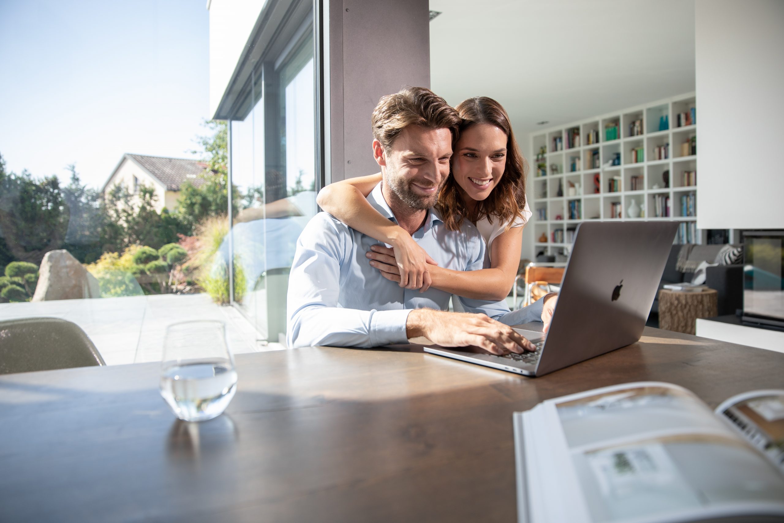 Woman embracing man working from home