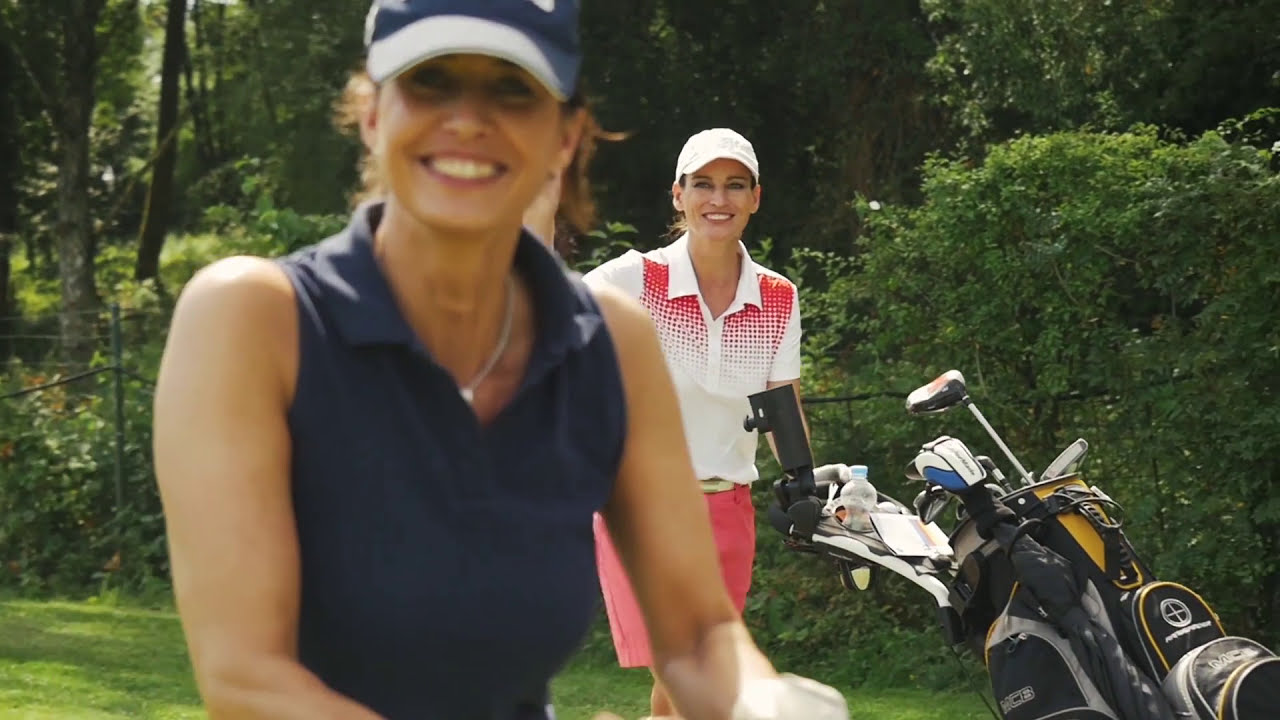 Female golfers smiling outdoors for Audi Quattro Cup film